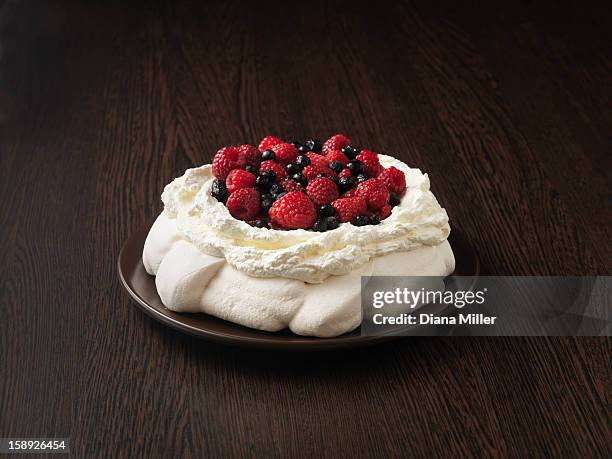 plate of fruit pavlova - pavlova dessert stock pictures, royalty-free photos & images