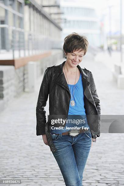 woman walking on city street - one mid adult woman only fotografías e imágenes de stock
