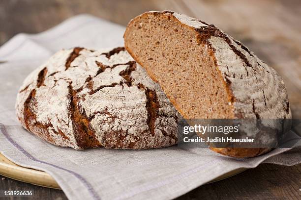 loaves of sourdough bread - backwaren stock-fotos und bilder