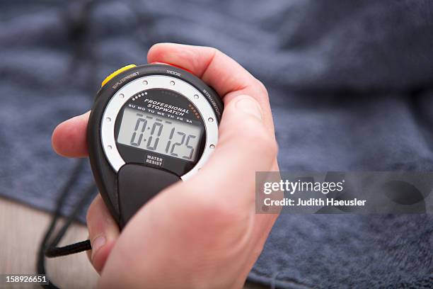 close up of hand holding stopwatch - stop watch stock pictures, royalty-free photos & images