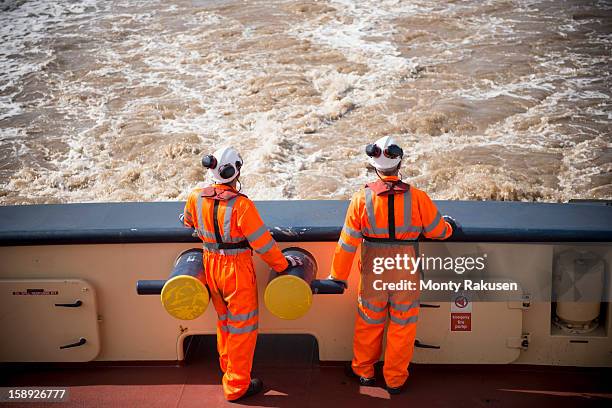 tug workers on deck of tug at sea - production crew stock pictures, royalty-free photos & images