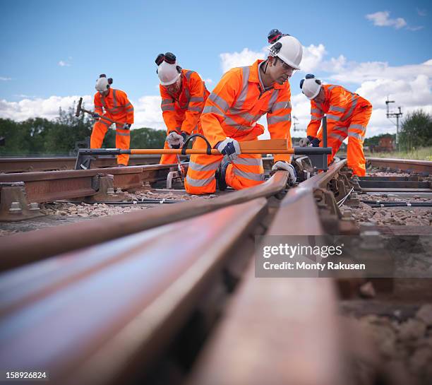 railway workers checking railway track is level, surface level view - rail worker stock pictures, royalty-free photos & images