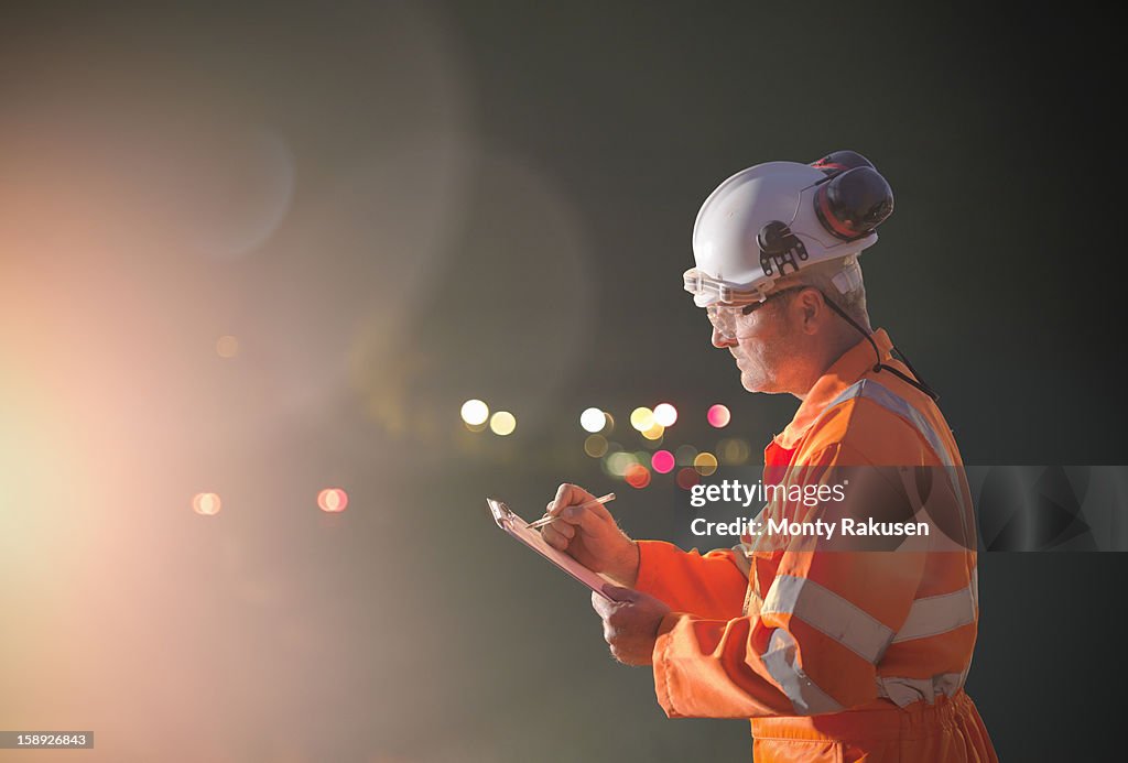 Railway worker making notes at night