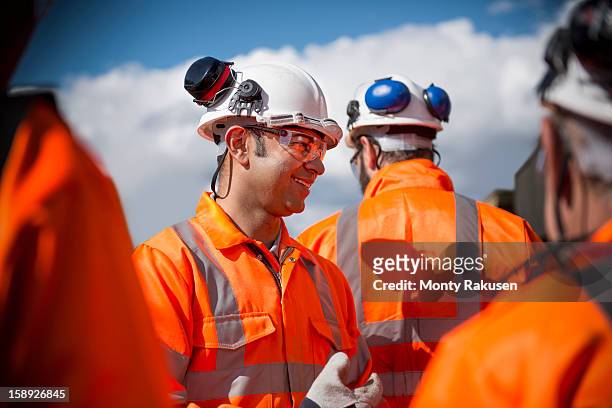 portrait of railway workers wearing protective clothing - mutual protection stock pictures, royalty-free photos & images