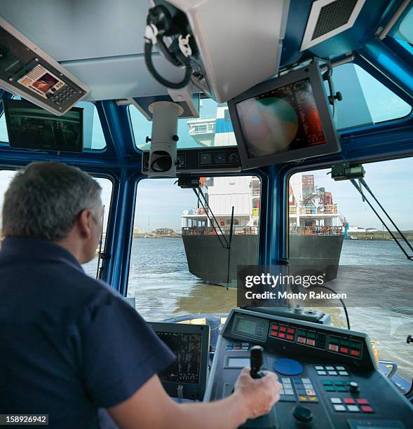 tug captain steering tug - boat gps stock-fotos und bilder