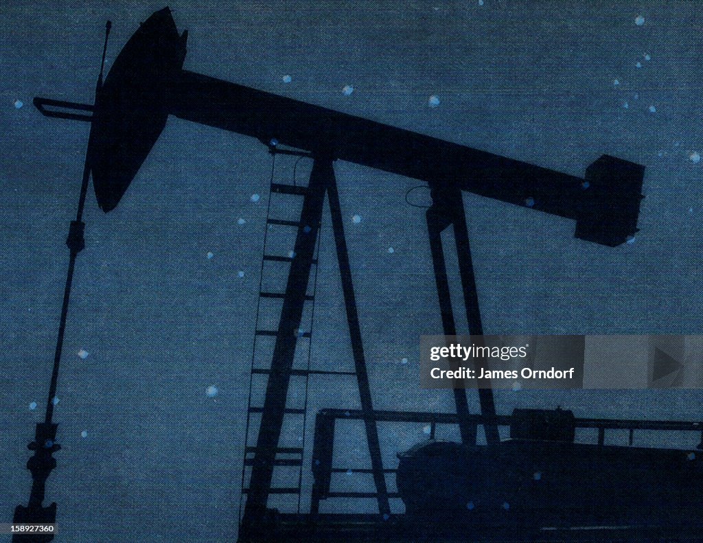 A silhouette of a oil rig