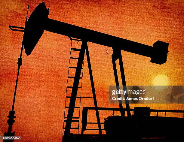 a silhouette of an oil rig - james orndorf stock illustrations