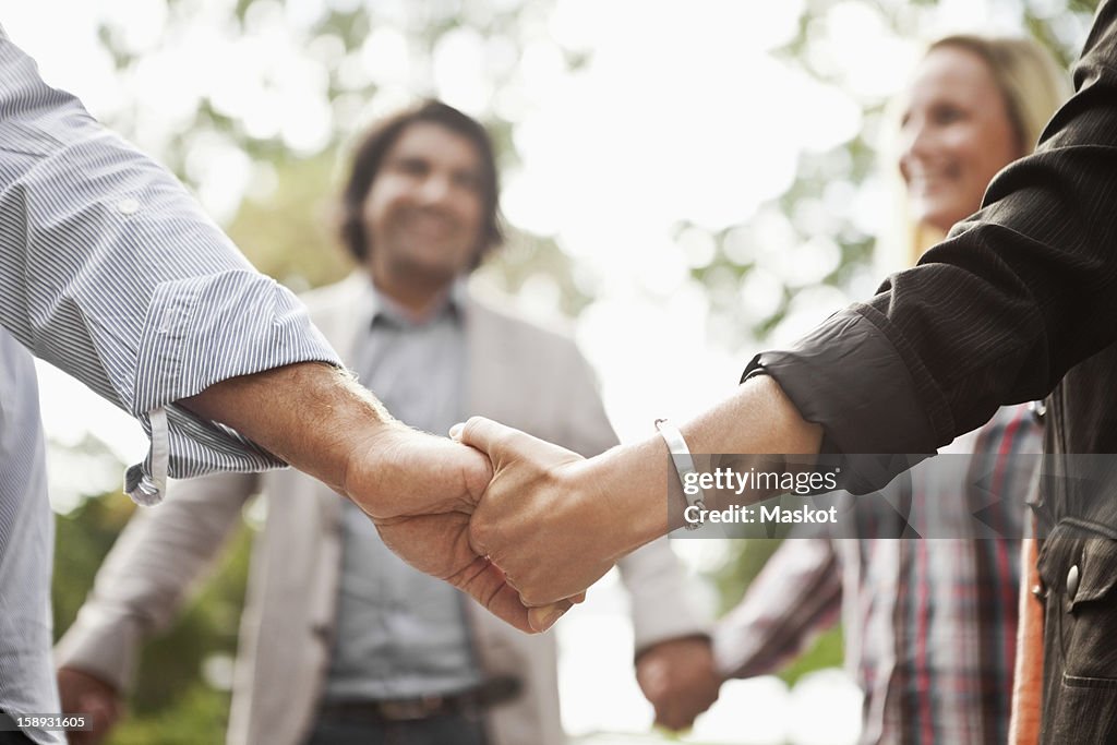 Group of people holding hands in a ring