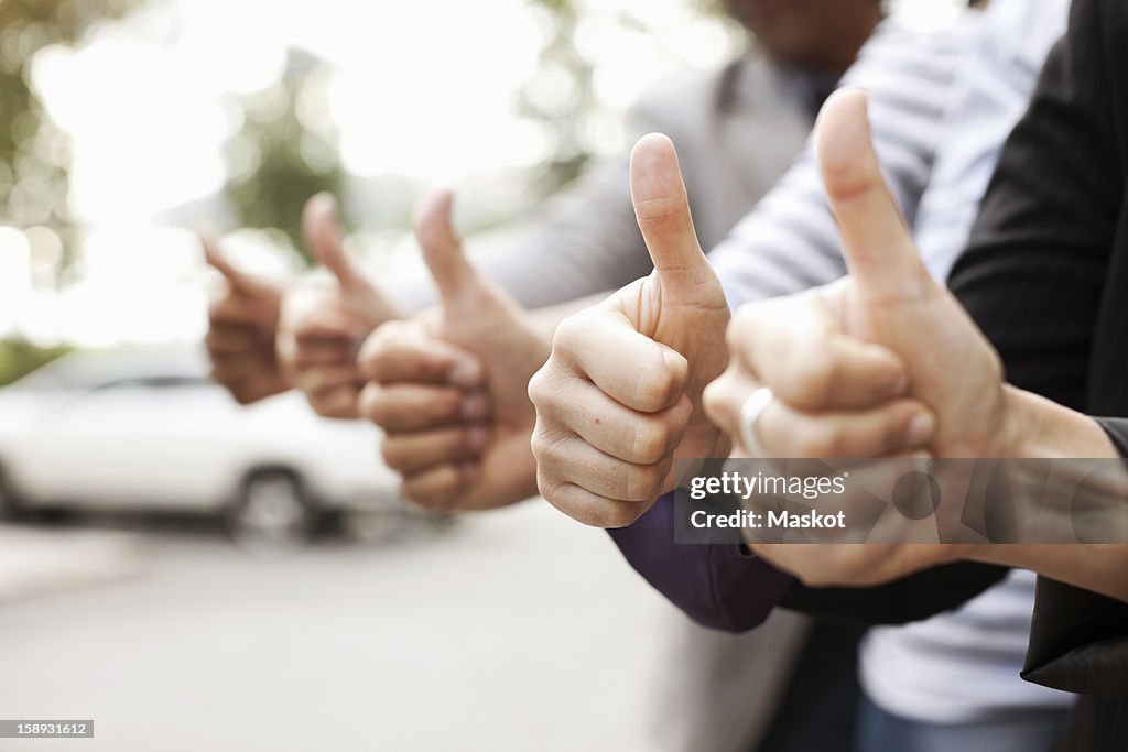 Human hands showing thumbs up sign