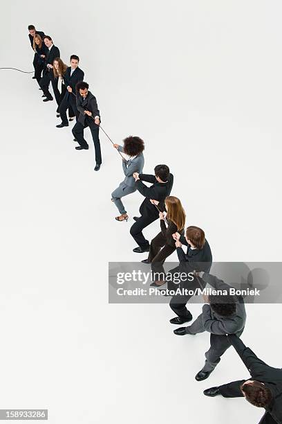 business professionals in tug-of-war match - man pulling object fotografías e imágenes de stock