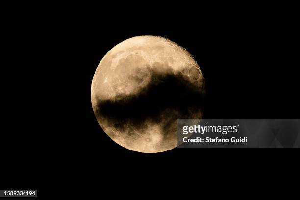 Clouds pass by Sturgeon Super Moon as seen on August 2, 2023 in Turin, Italy. This is the first of two super moons in the month of August, with the...