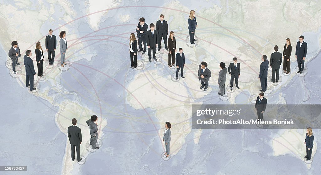 Large group of business people standing on world map