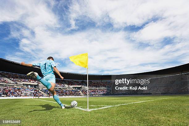 soccer player taking a corner kick - corner kick stock-fotos und bilder