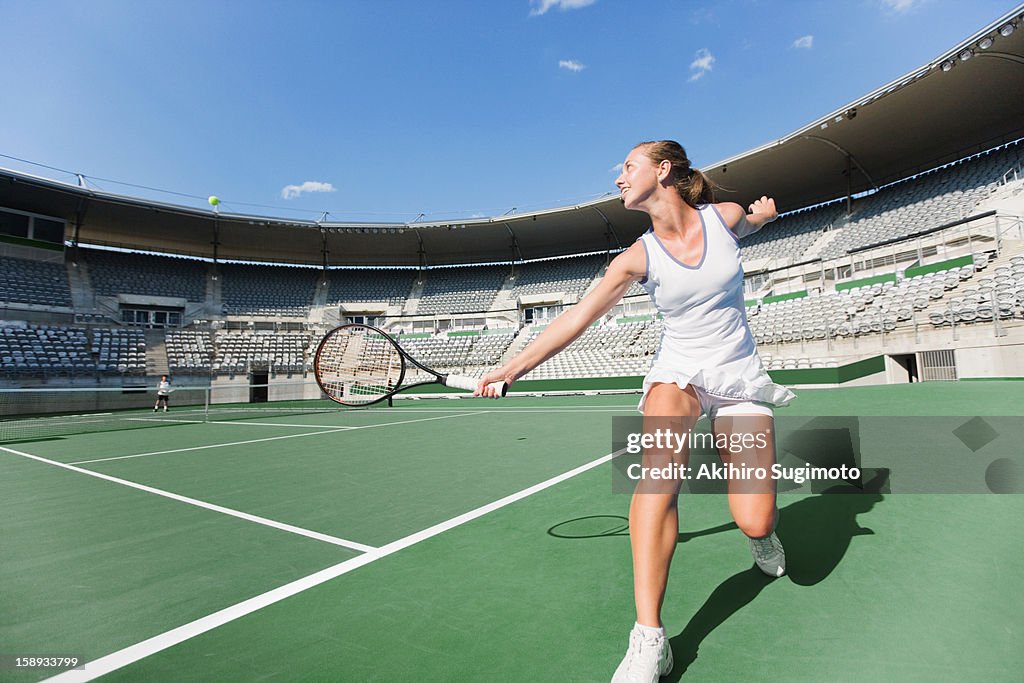 Tennis player hitting backhand return