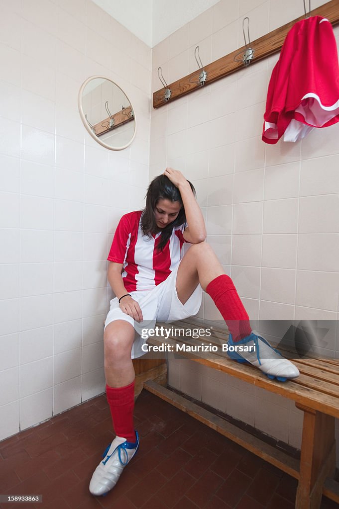 Soccer player sitting on bench