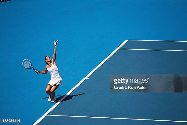 young female tennis player - serving sport stock pictures, royalty-free photos & images