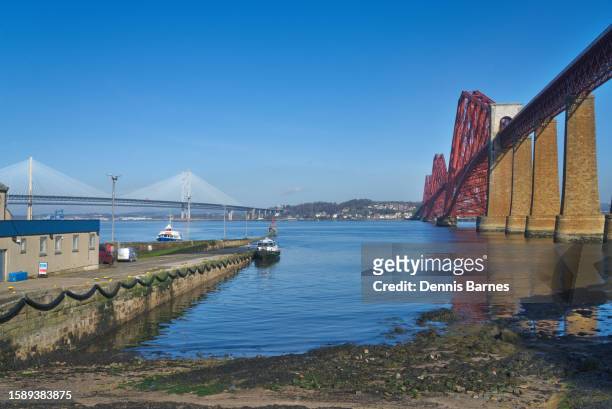 new 'queensferry crossing' bridge over river forth at south queensferry.  viewed from old pier. - rosyth stock pictures, royalty-free photos & images