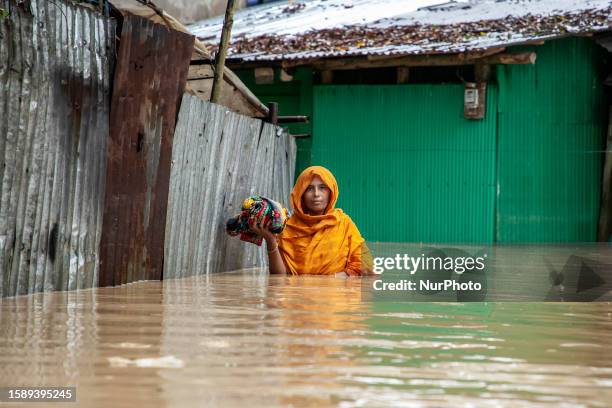 Pedestrians walk through flooded roads in Satkania Upazila of South Chittagong, Bangladesh in high level water. The life of the people of Satkania...