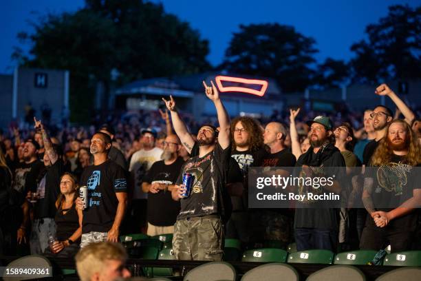 Audience members flash the devil horn gesture as Pantera and Lamb Of God perform at Freedom Mortgage Pavilion on August 02, 2023 in Camden, New...