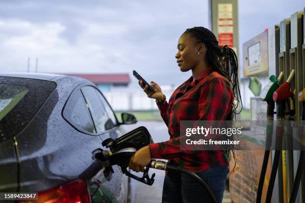 woman at the gas station - petrol station stock pictures, royalty-free photos & images