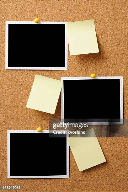 blank polaroid with yellow sticky note pinned on cork board - bulletin board border stock pictures, royalty-free photos & images