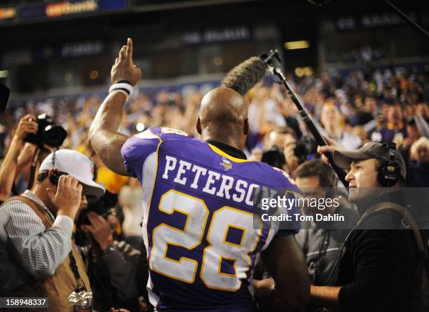 Adrian Peterson of the Minnesota Vikings acknowledges fans after an NFL game against the Green Bay Packers at the Hubert H. Humphrey Metrodome, on...