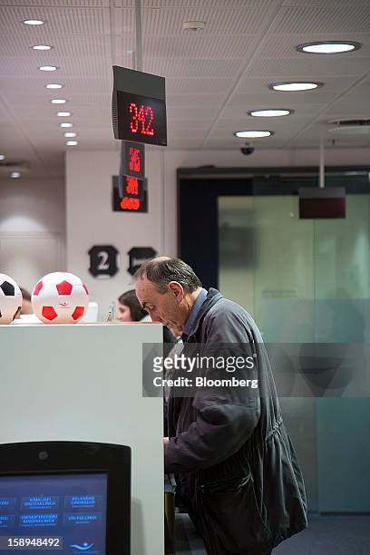 Customers stand at the counter of an Islandbanki hf bank branch in Reykjavik, Iceland, on Wednesday, Jan. 2, 2013. Creditors of Iceland's three...