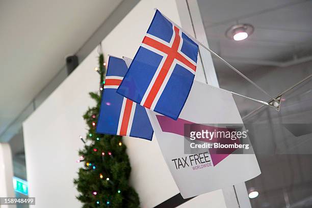 Icelandic national flags hang from a display advertising tax free goods at the Kringlan shopping center in Reykjavik, Iceland, on Wednesday, Jan. 2,...