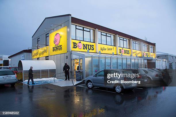 Customers stand outside the entrance to a Bonus grocery store, owned by Baugar Group hf, in Reykjavik, Iceland, on Wednesday, Jan. 2, 2013. Creditors...