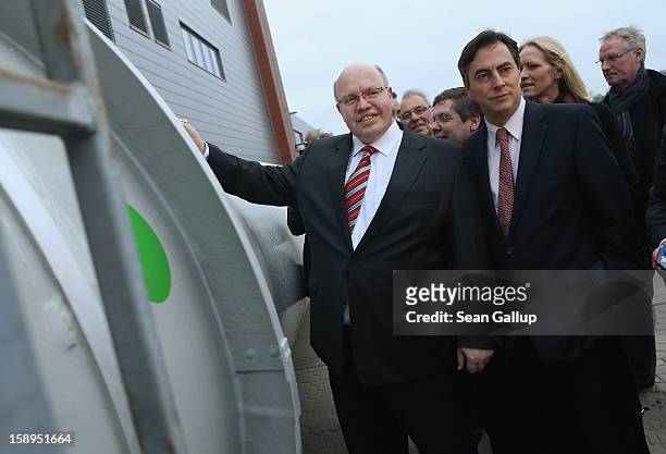 Lower Saxony Governor and incumbant candidate of the German Christian Democrats David McAllister and German Environment Minister Peter Altmaier sign...