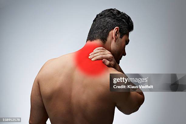 man having shoulder pain (rear view) - human neck stock pictures, royalty-free photos & images