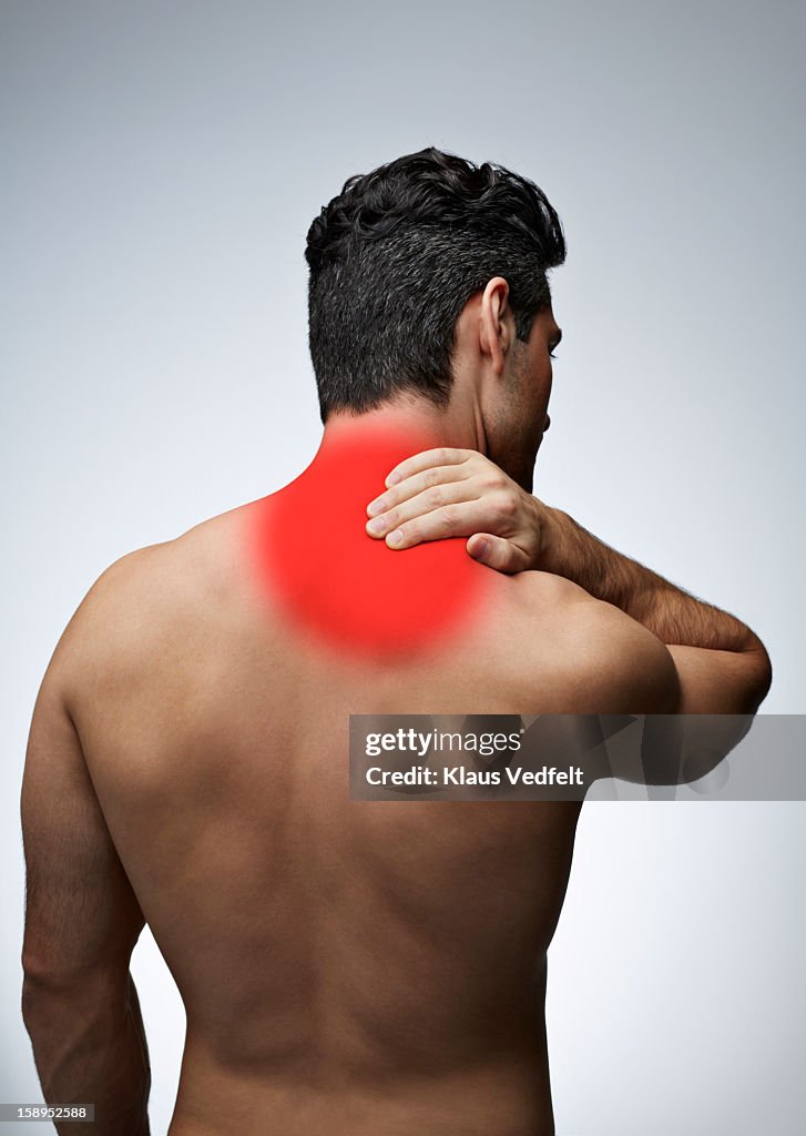 Man having shoulder pain (rear view)