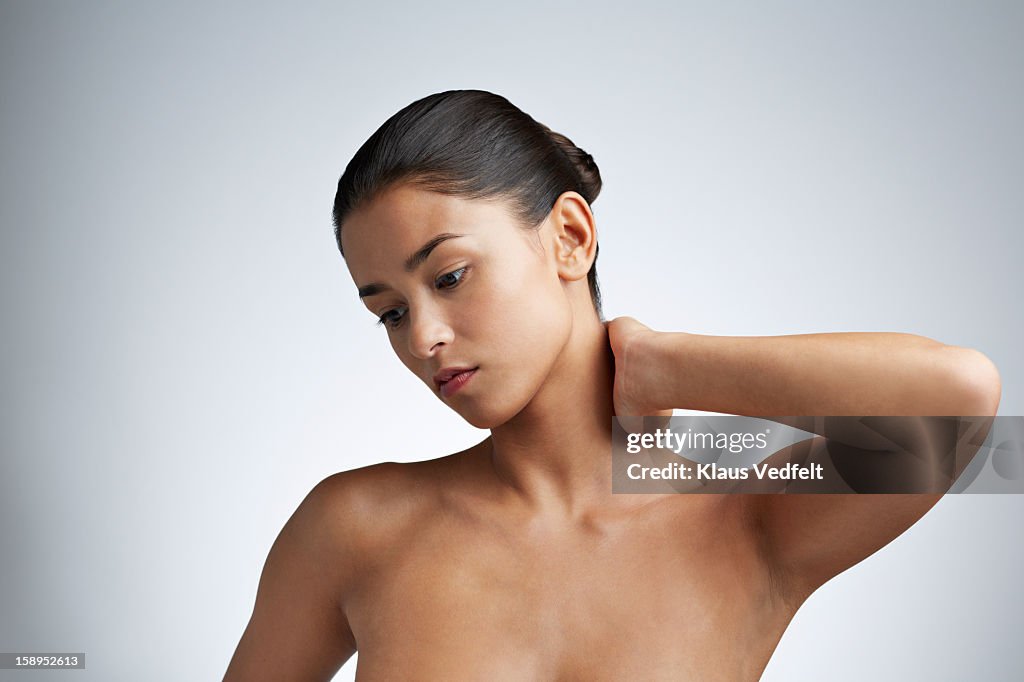 Close up of woman having neck pain (front view)