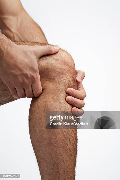 close-up of man having knee pain - human knee stock pictures, royalty-free photos & images