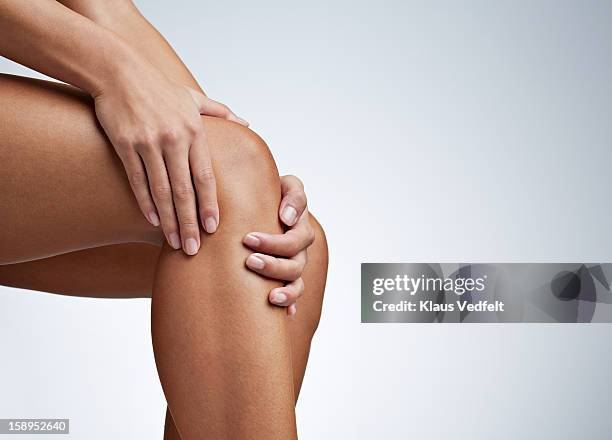 close up of woman having knee pain - människoknä bildbanksfoton och bilder