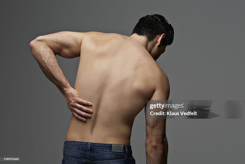 Man having lower back pain (rear view)