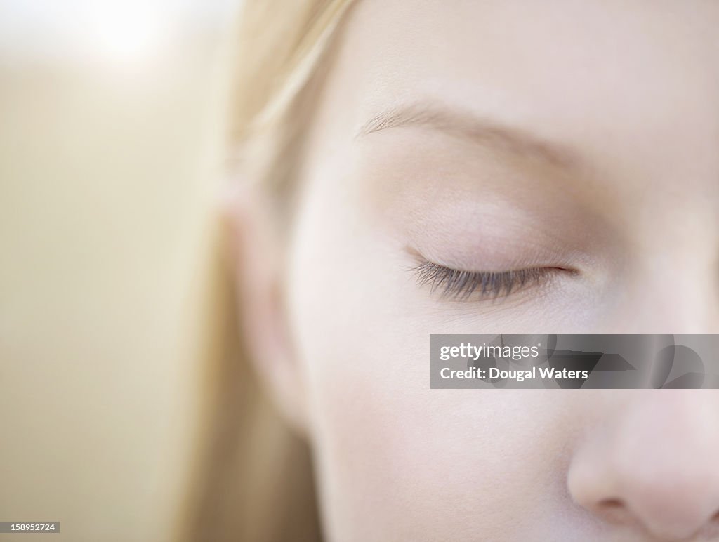 Close up of woman with eye closed.