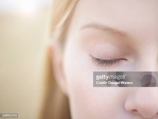 close up of woman with eye closed. - eyes closed close up stock pictures, royalty-free photos & images