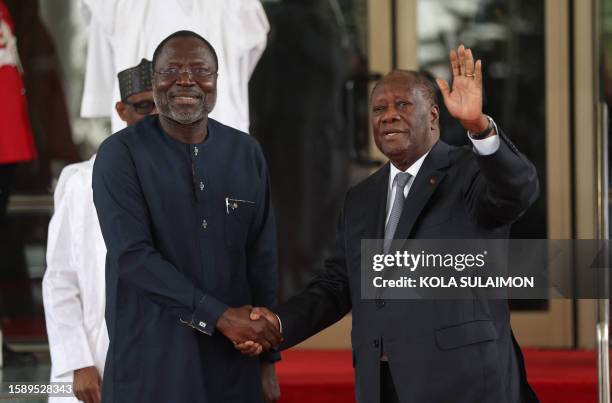 Ivory Coast President Alassane Ouattara waves to the press upon his arrival at the Economic Community of West African States Head of States and...