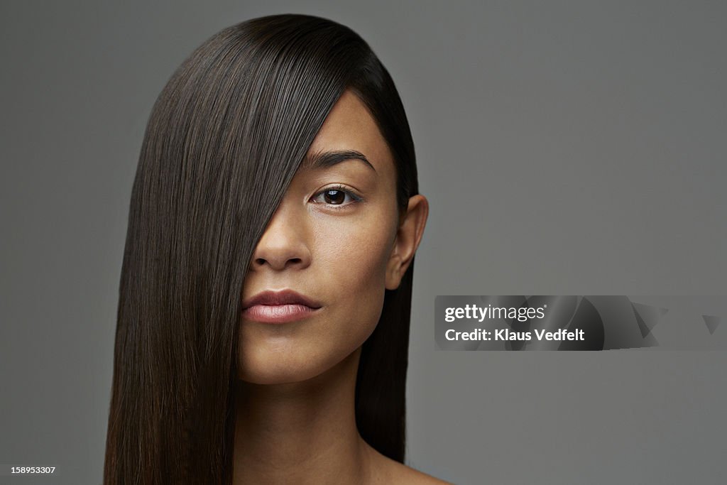 Portrait of woman with hair covering half the face