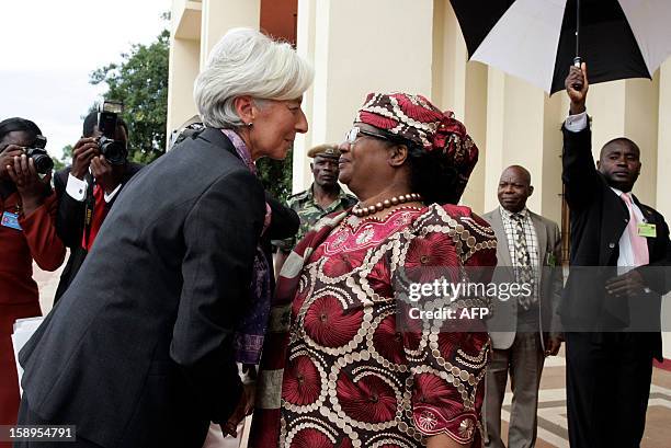 International Monetary Fund Managing Director Christine Lagarde is greeted by Malawi’s President Joyce Banda on arrival at Kamuzu Palace in Lilongwe...