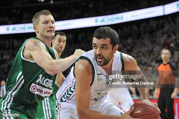 Krunoslav Simon, #4 of Unicaja Malaga competes with Rimantas Kaukenas, #21 of Zalgiris Kaunas in action during the 2012-2013 Turkish Airlines...