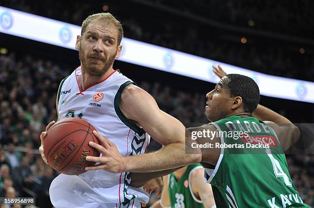 Luka Zoric, #21 of Unicaja Malaga competes with Tremmell Draden, #4 of Zalgiris Kaunas in action during the 2012-2013 Turkish Airlines Euroleague Top...