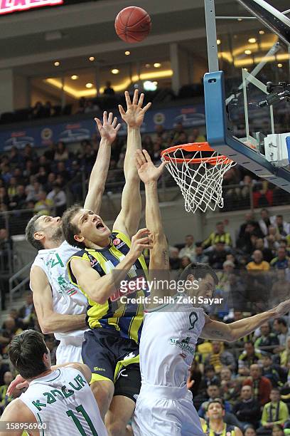 Bojan Bogdanovic of Fenerbahce Ulker competes with Marco Carraretto and Benjamin Ortner of Montepaschi Siena during the 2012-2013 Turkish Airlines...