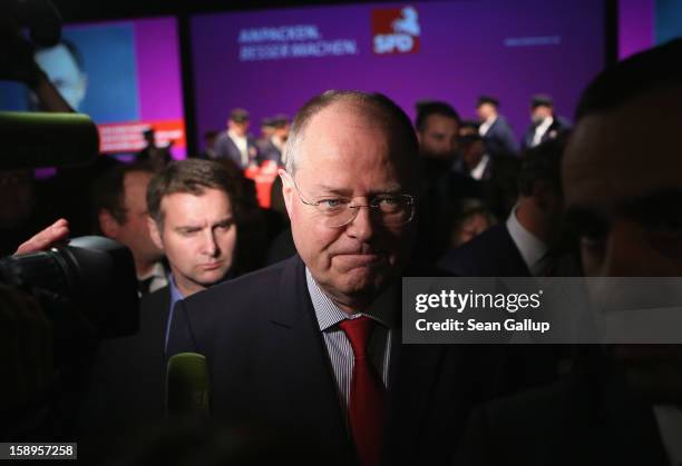 Peer Steinbrueck, chancellor candidate of the German Social Democrats , departs at the end of a Lower Saxony SPD state election rally on January 4,...