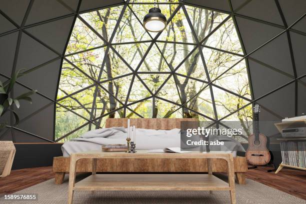 geodesic dome house with forest view and wooden furniture - luxury tent stock pictures, royalty-free photos & images