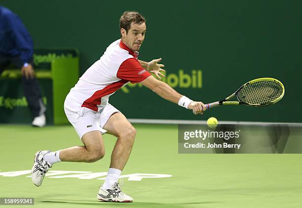 Richard Gasquet of France plays a backhand during his semi-final against Daniel Brands of Germany in day five of the Qatar Open 2013 at the Khalifa...