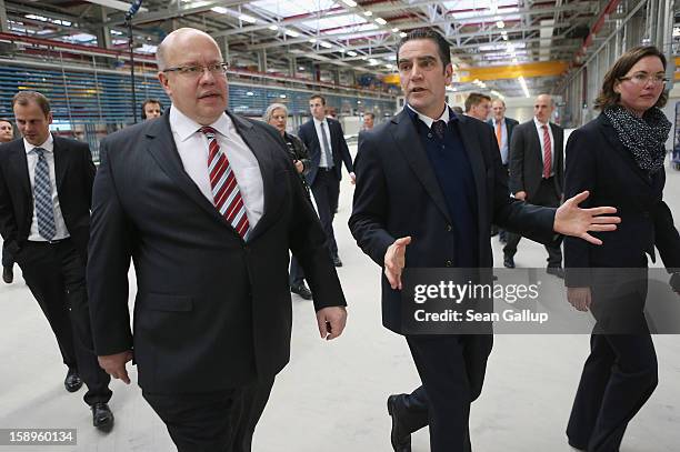 German Environment Minister Peter Altmaier of the German Christian Democrats tours the Enercon wind turbine factory with Enercon head Hans-Dieter...