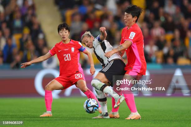 Alexandra Popp of Germany is challenged by Kim Hyeri and Park Eunsun of Korea Republic during the FIFA Women's World Cup Australia & New Zealand 2023...