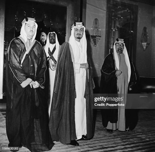 In centre, Prince Faisal of Saudi Arabia attends a diplomatic reception with, on left, Sheikh Hafiz Wahba in London in January 1946.